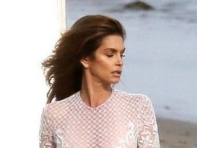 Cindy Crawford Modeling In A Sheer White Dress On The Beach