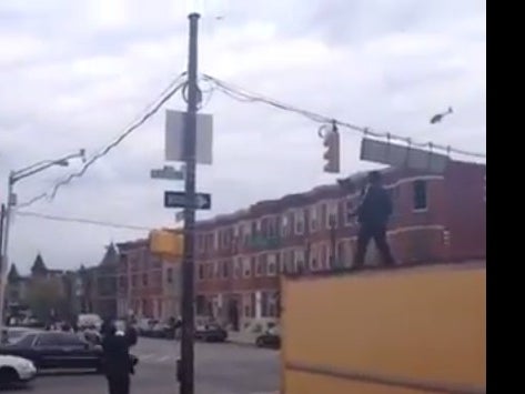 It's Chaos In The Streets Of Baltimore... But Don't Tell This Dude Breakdancing On Top Of A Box Truck