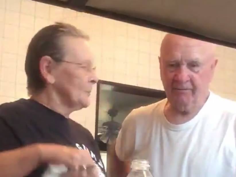 An Older Couple Having A Laugh With A Water Bottle Prank Will Cheer You Up